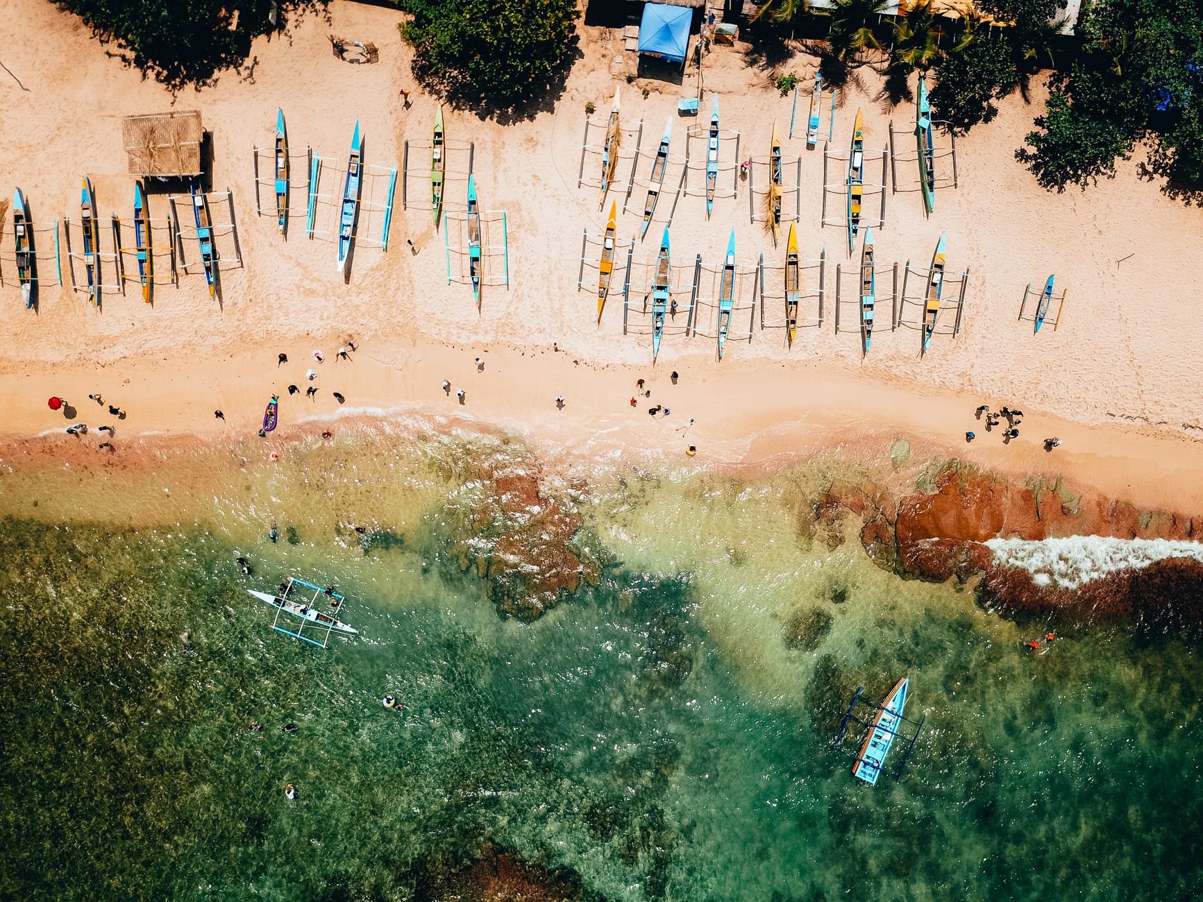 drone shot of fishing boats on the shore
